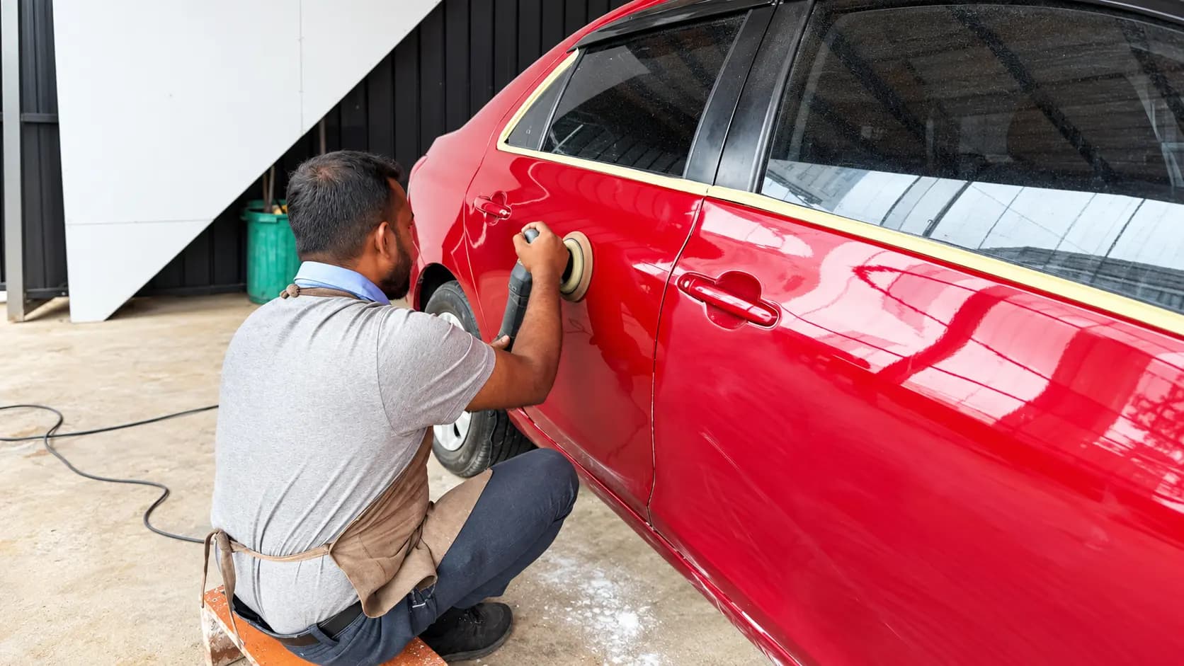 EasyCare technician machine polishing a red vehicle