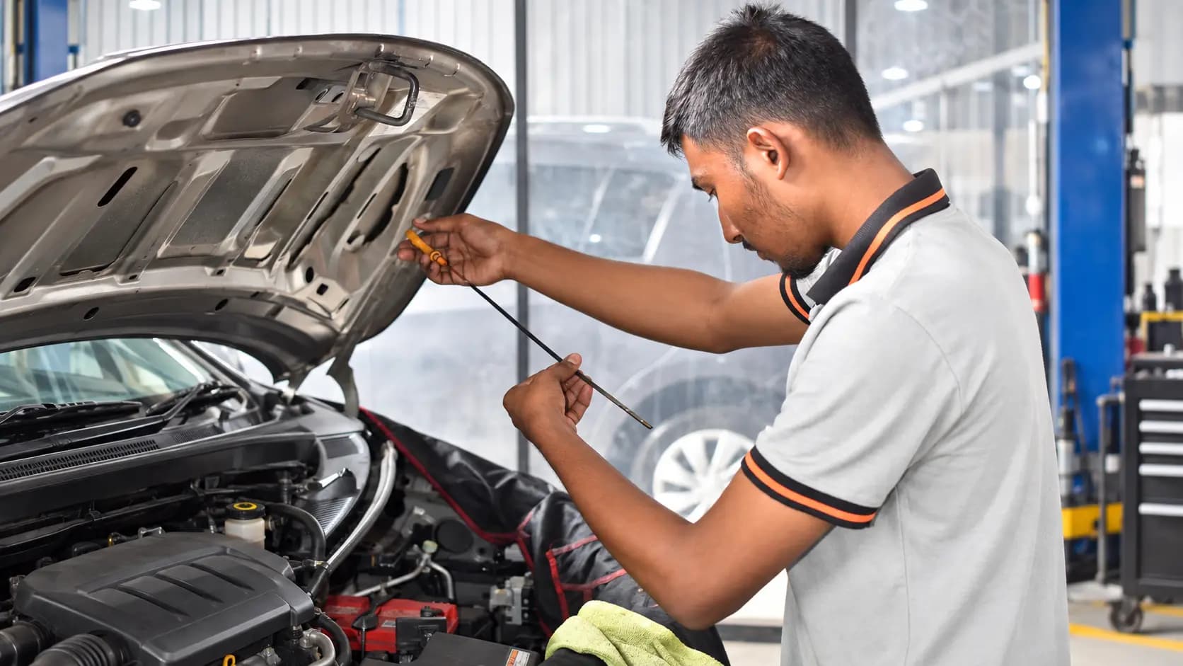 EasyCare technician checking a vehicle's engine oil level