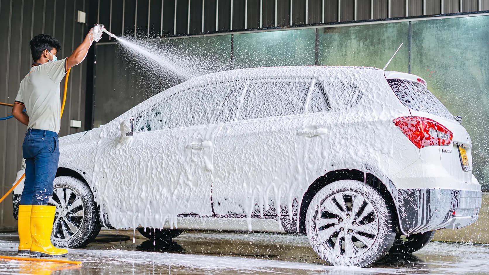 EasyCare technician foam washing a customer vehicle
